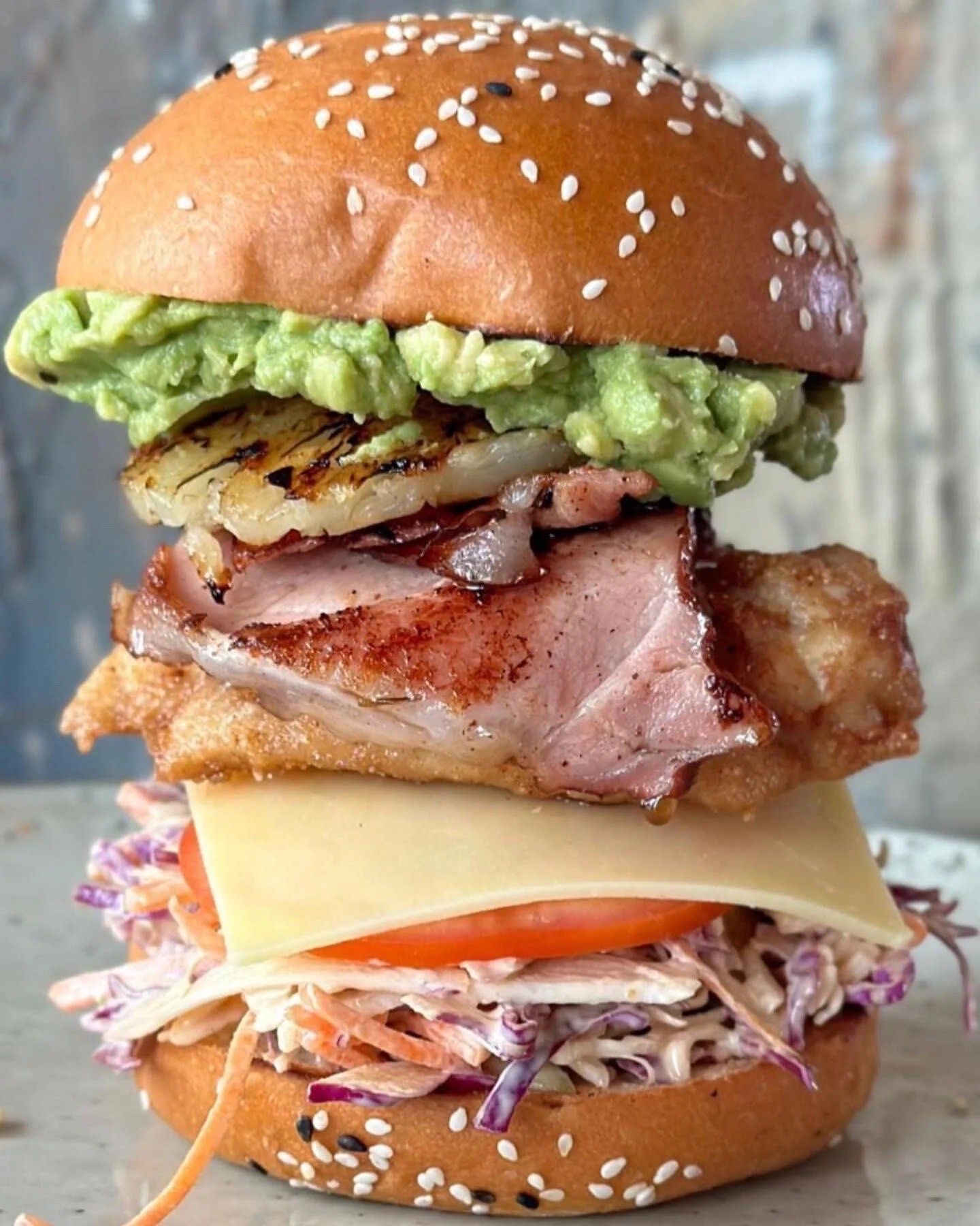 Stacked chicken burger with grilled pineapple, slaw and smashed avocado at Haig St Cafe